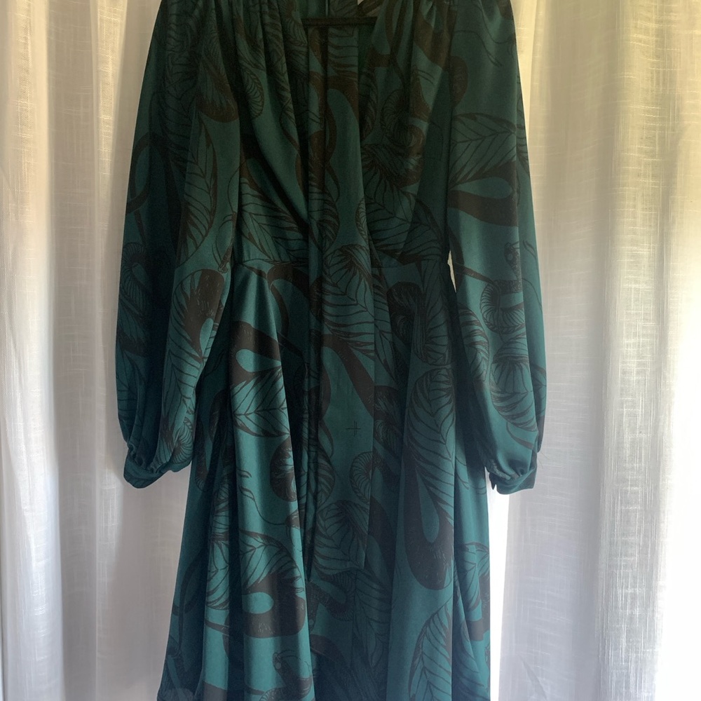 La Femme En Noir (brand) serpentine wrap dress in dark green and black.